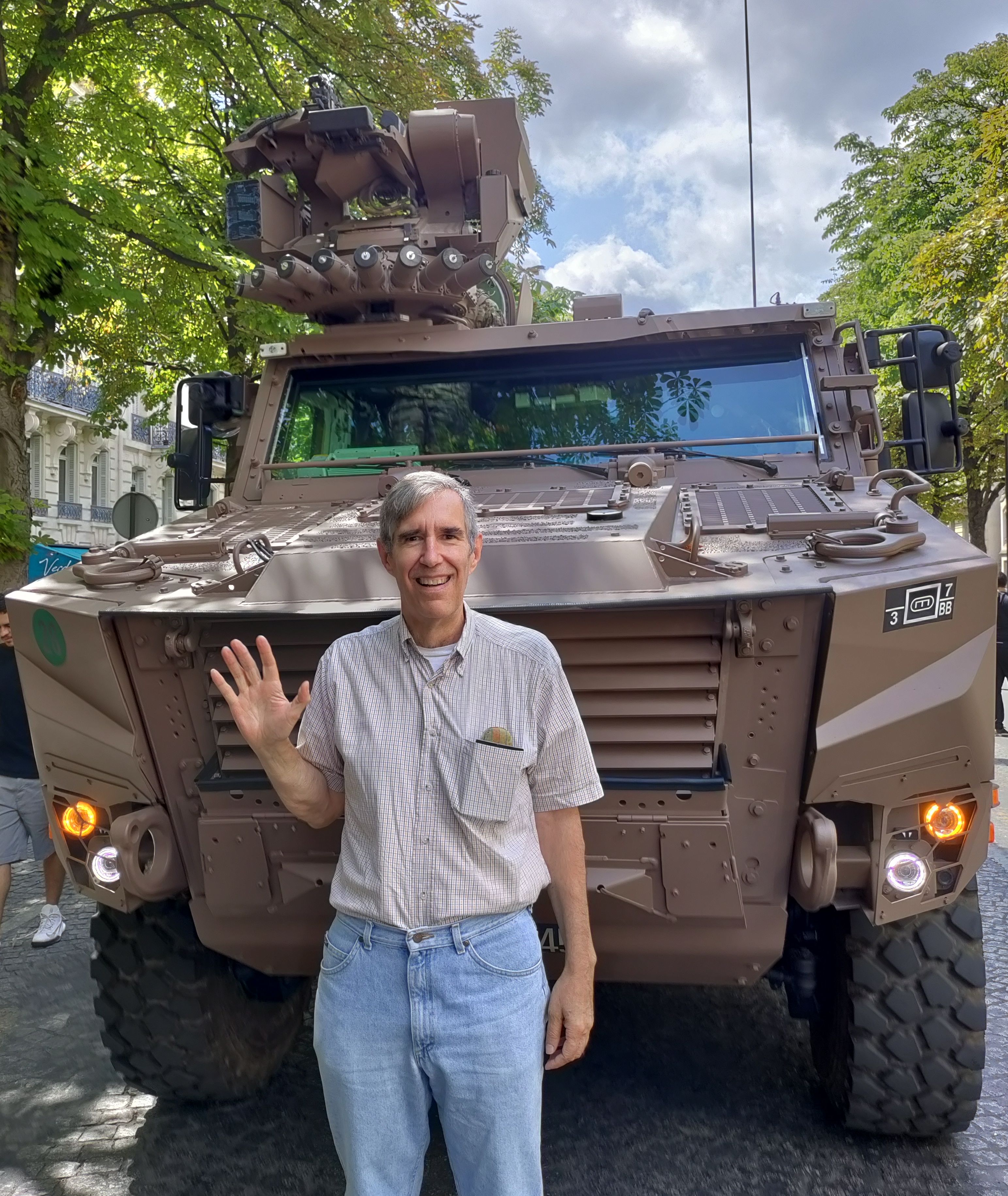 In front of a military vehicle on Avenue Geroge V immediately after the end of the Bastille Day parade.
